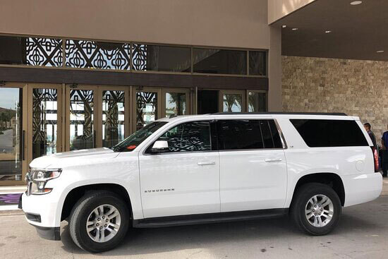 White Suburban Luxury SUV at hotel lobby