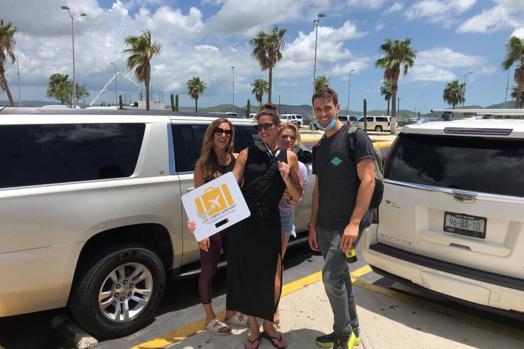 Group of four friends being picked up on a white Escalade luxury SUV 