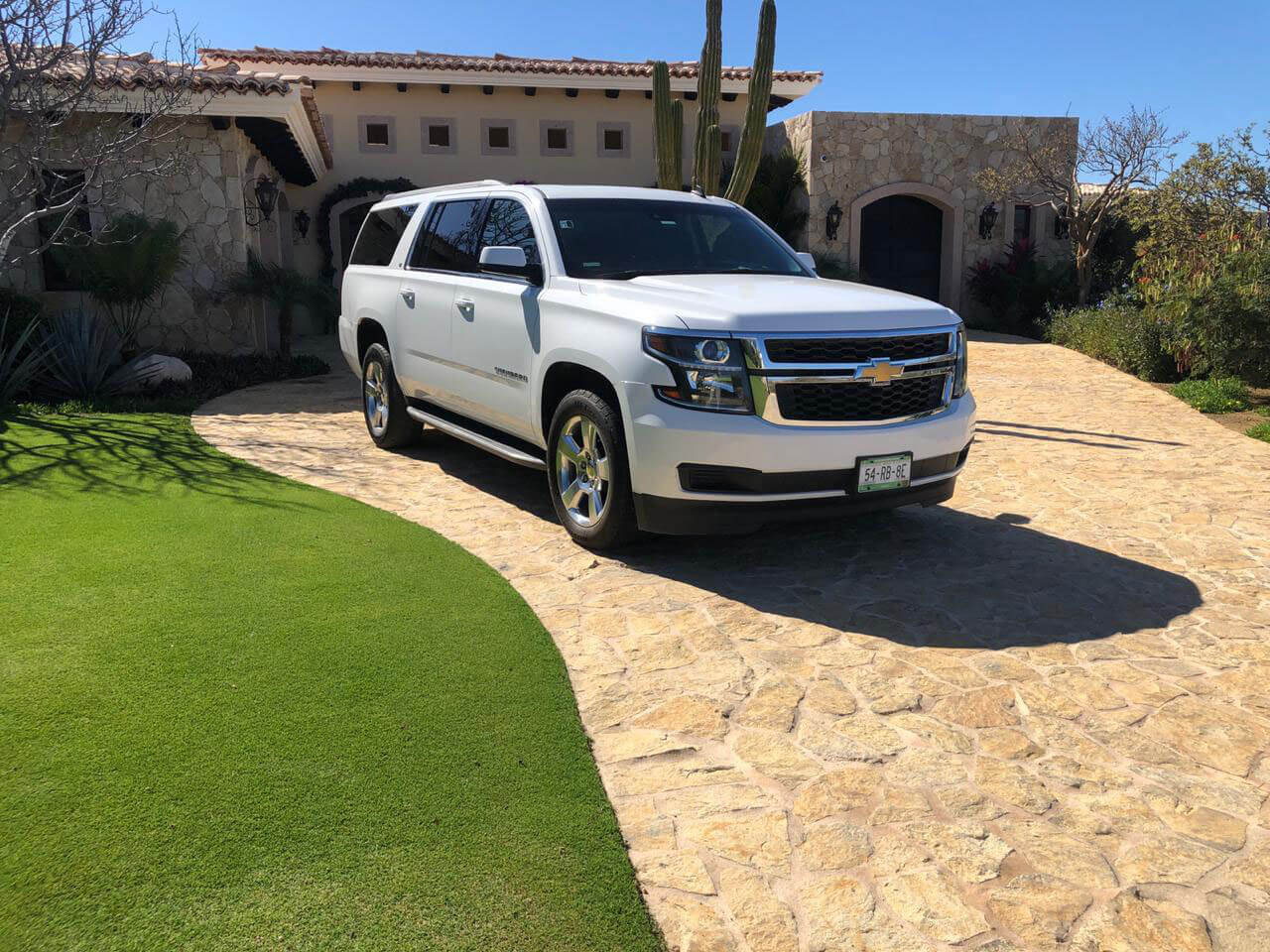 White Luxury SUV leaving private residence
